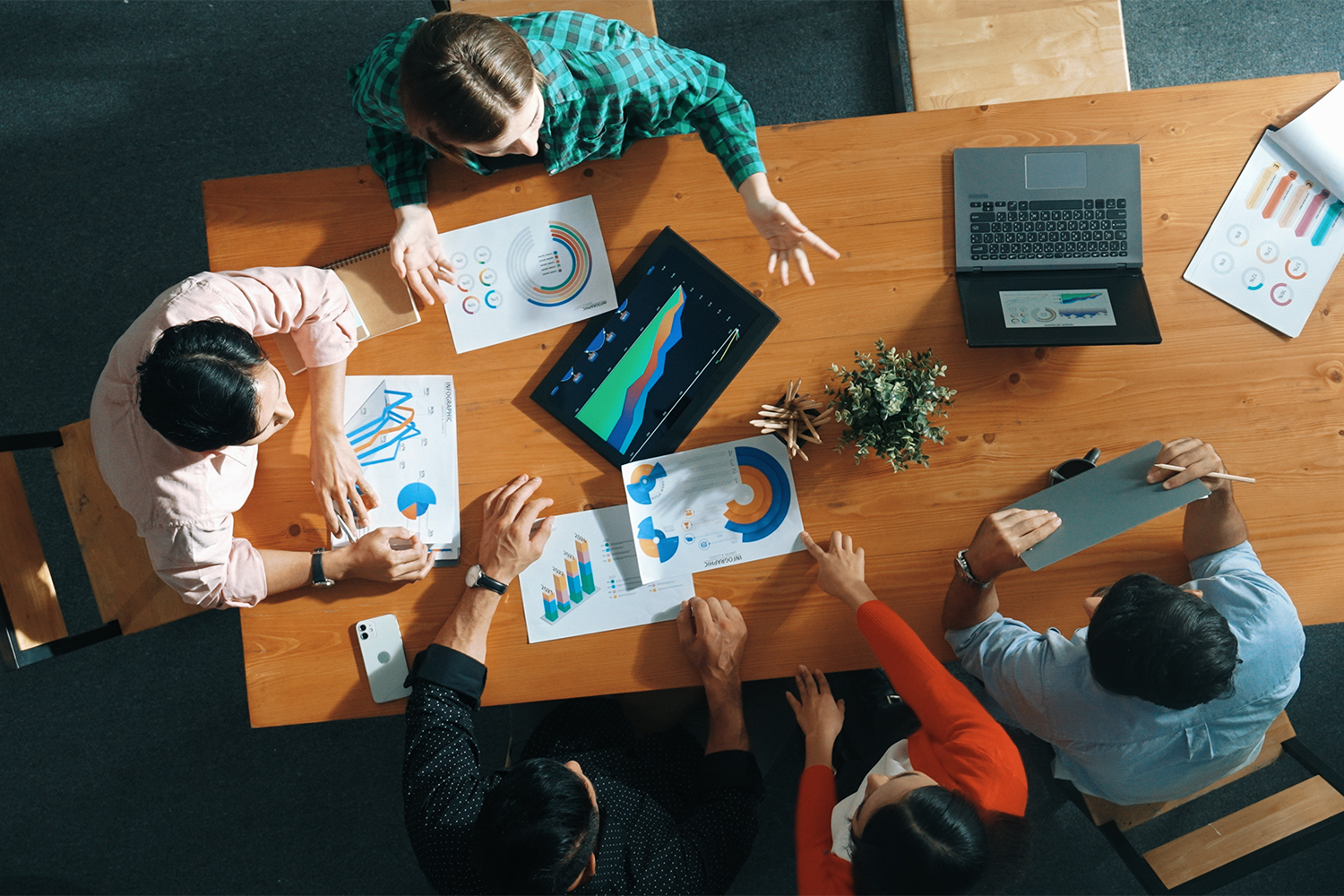 Alt text: Top down view of smart business woman explain and present chart.