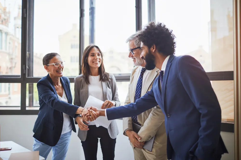 ALT Text: businessman and businesswoman outdoor talking and handshaking