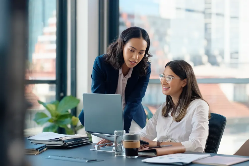ALT Text: Business people, laptop or learning in training in discussion or conversation for news, education or advice.