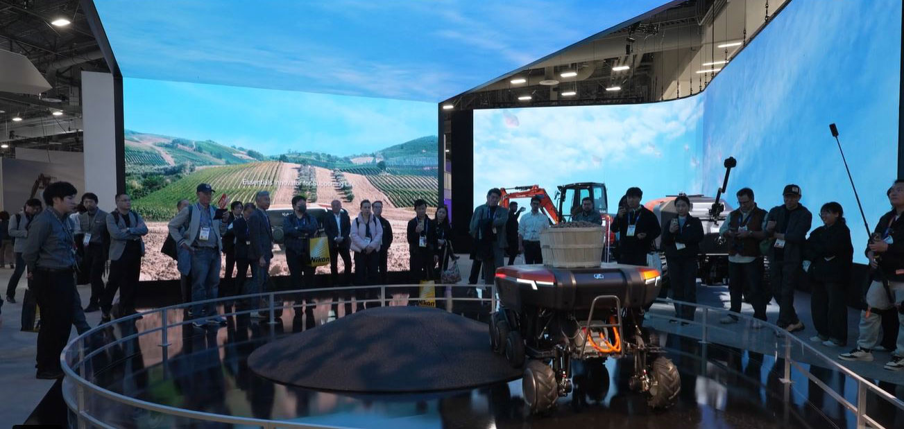 ALT Text: a big display with people surrounding  