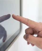 User tapping a touch screen with the Smart Home Energy Management System (SHEMS)
