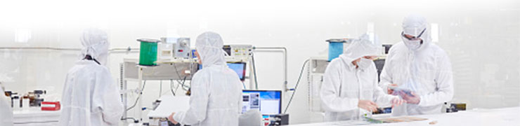 Lab workers performing tests on electronic equipment